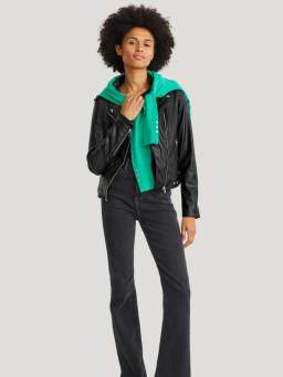 Travel outfits: a black biker jacket with blue jeans.  Travel outfits: a black biker jacket with blue jeans.