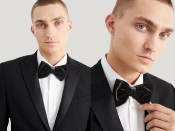How to tie a bow tie: a man wearing a black suit with a matching bow tie.  How to tie a bow tie: a man wearing a black suit with a matching bow tie.