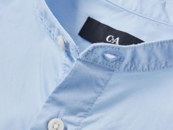 Shirt collar types: a close-up shot of a grandad collar shirt.  Shirt collar types: a close-up shot of a grandad collar shirt.