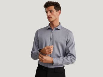 How to measure for a shirt: a man wearing a business shirt with a good fit. How to measure for a shirt: a man wearing a business shirt with a good fit.