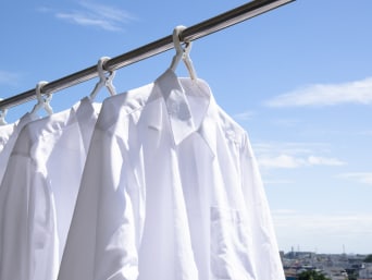 Drying shirts: shirts hung up on hangers and drying outside. Drying shirts: shirts hung up on hangers and drying outside.