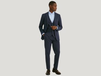 Suit fit: a man wearing a slim fit suit with a waistcoat. Suit fit: a man wearing a slim fit suit with a waistcoat.