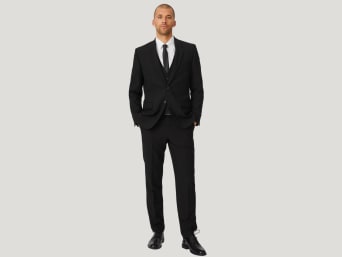 A man wearing a regular fit suit. A man wearing a regular fit suit.