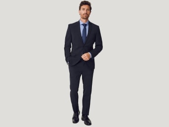 A man wearing a slim fit suit. A man wearing a slim fit suit.