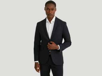 A man wearing a skinny fit suit. A man wearing a skinny fit suit.