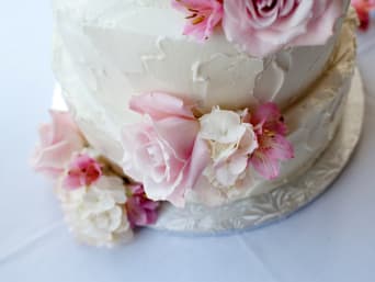 Beispiel für eine Babyparty-Torte: Torte mit Frischkäsecreme und rosa Blüten als Verzierung. Beispiel für eine Babyparty-Torte: Torte mit Frischkäsecreme und rosa Blüten als Verzierung.