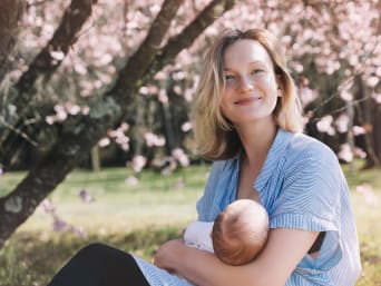 Finding a comfortable breastfeeding bra: a mother nursing her baby. Finding a comfortable breastfeeding bra: a mother nursing her baby.