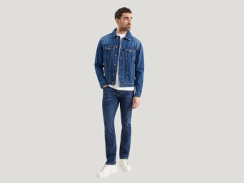 What are slim fit jeans? – a man wearing a pair of slim fit jeans. What are slim fit jeans? – a man wearing a pair of slim fit jeans.