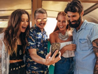 Men’s festival outfits: a group of friends taking a selfie.  Men’s festival outfits: a group of friends taking a selfie.