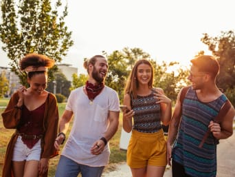 Men’s festival clothing: a group of friends walking to a festival. Men’s festival clothing: a group of friends walking to a festival.