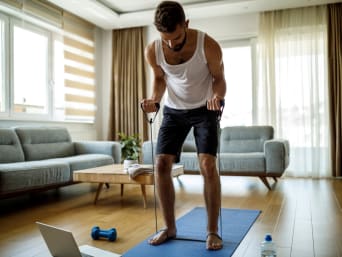 Man training at home using fitness tubes. Man training at home using fitness tubes.