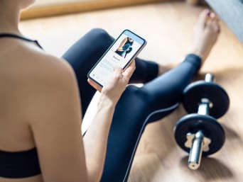 Online fitness course: woman viewing a video workout in a fitness app. Online fitness course: woman viewing a video workout in a fitness app.