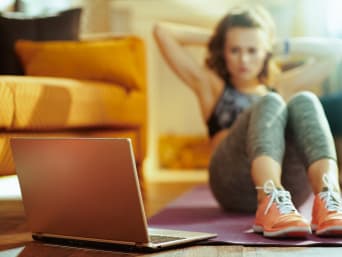 Online fitness: young woman training with instruction from a video workout. Online fitness: young woman training with instruction from a video workout.