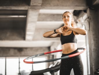 Hula hoop – woman training with a hula hoop. Hula hoop – woman training with a hula hoop.