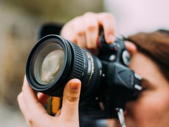 The ideal camera for beginners – an amateur photographer taking photos with her first camera. The ideal camera for beginners – an amateur photographer taking photos with her first camera.
