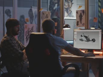 Spieleentwicklung: Game Designer bei der Arbeit an 3D-Modellen am Computer. Spieleentwicklung: Game Designer bei der Arbeit an 3D-Modellen am Computer.