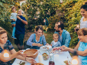 Ideas for a garden party: a family sitting round a table at a garden party.  Ideas for a garden party: a family sitting round a table at a garden party.