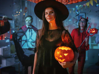 Simple Halloween costumes: a woman wearing a witch costume at a Halloween party. Simple Halloween costumes: a woman wearing a witch costume at a Halloween party.