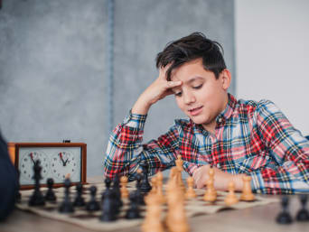 Schach Vorteile – Bub bei einem Schachspiel. Schach Vorteile – Bub bei einem Schachspiel.
