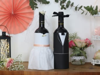 Creative wrapping for wedding gifts: two bottles of wine presented as a bride and groom. Creative wrapping for wedding gifts: two bottles of wine presented as a bride and groom.