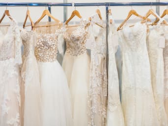 Different types of wedding dresses: wedding dresses hung up in a bridal shop. Different types of wedding dresses: wedding dresses hung up in a bridal shop.