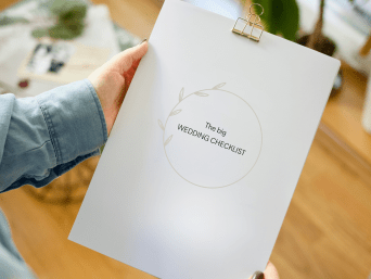 Planning a wedding: a woman holding a checklist for her wedding. Planning a wedding: a woman holding a checklist for her wedding.