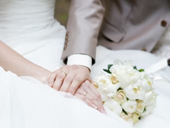 Trouwen: bruid en bruidegom houden elkaars hand vast Trouwen: bruid en bruidegom houden elkaars hand vast