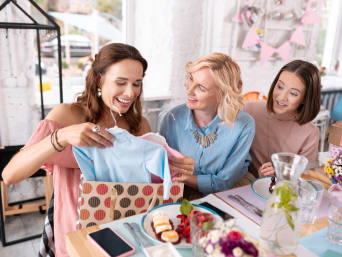 Unwrapping gifts at a baby shower.  Unwrapping gifts at a baby shower.