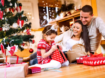 Christmas presents for children – a family unwrapping Christmas presents together. Christmas presents for children – a family unwrapping Christmas presents together.