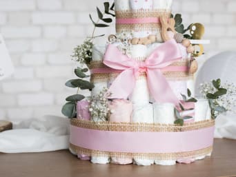 Baby gifts: a brightly decorated nappy cake for a girl. Baby gifts: a brightly decorated nappy cake for a girl.
