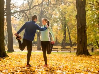 Running in the cold: two runners do a cool-down in a park. Running in the cold: two runners do a cool-down in a park.