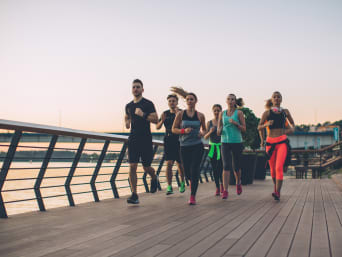 Running for beginners: a group of runners jogging together over a bridge. Running for beginners: a group of runners jogging together over a bridge.
