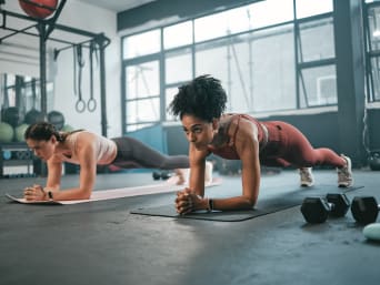 Strength training for runners: two women strengthening their core by doing plank exercises. Strength training for runners: two women strengthening their core by doing plank exercises.