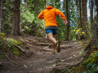Trail running for beginners: a runner going for a run in a forest. Trail running for beginners: a runner going for a run in a forest.