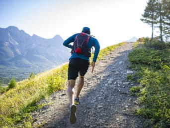 Trail running gear: a runner with a running backpack. Trail running gear: a runner with a running backpack.