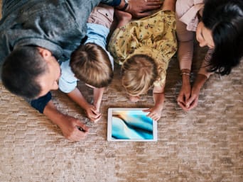 Media education: Family is looking at a tablet together. Media education: Family is looking at a tablet together.