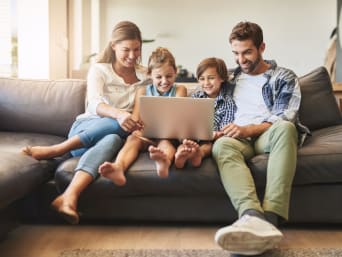 Safe media use for children: Family is sitting in front of laptop and surfs the internet. Safe media use for children: Family is sitting in front of laptop and surfs the internet.