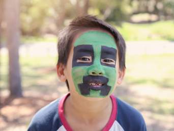 Minecraft birthday party games: a child’s face painted as a creeper.  Minecraft birthday party games: a child’s face painted as a creeper.