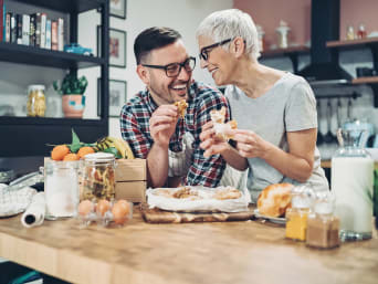 Mother and son spend time together and eat homemade cake. Mother and son spend time together and eat homemade cake.
