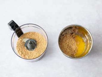Cookies are crushed and mixed with melted butter. Cookies are crushed and mixed with melted butter.