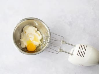 Cream cheese sugar mixture is mixed with eggs. Cream cheese sugar mixture is mixed with eggs.