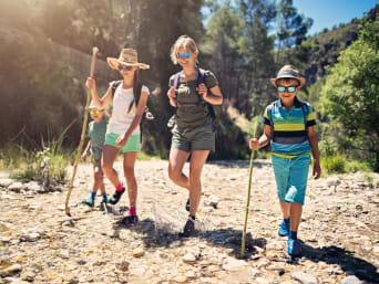 Eco-friendly holidays: a family hiking in the mountains. Eco-friendly holidays: a family hiking in the mountains.