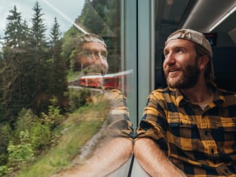 Eco-travel: a man travelling by train Eco-travel: a man travelling by train