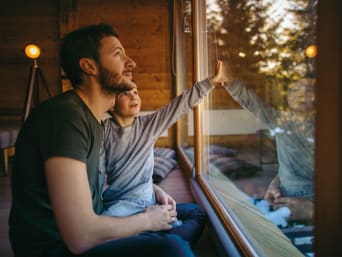 Sustainable accommodation: a father and son spending their holiday in a holiday home. Sustainable accommodation: a father and son spending their holiday in a holiday home.