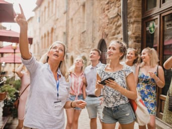 Soft tourism: a group of holidaymakers on a city tour in Volterra.