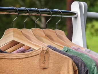 Sustainable clothes hanging on wooden hangers. Sustainable clothes hanging on wooden hangers.