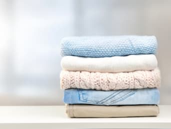 Helpful capsule wardrobe checklists: a small pile of clothes from a Capsule Wardrobe. Helpful capsule wardrobe checklists: a small pile of clothes from a Capsule Wardrobe.
