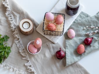 Eier natürlich färben: Bunte, natürlich gefärbte Ostereier auf einem Tisch. Eier natürlich färben: Bunte, natürlich gefärbte Ostereier auf einem Tisch.