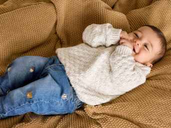 Newborn baby supplies checklist: A happy baby on a blanket. Newborn baby supplies checklist: A happy baby on a blanket.