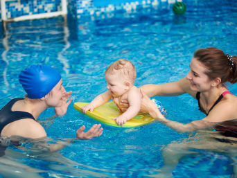Mother enjoying the closeness with her child during baby swimming. Mother enjoying the closeness with her child during baby swimming.